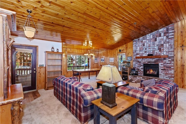 carpeted living area with vaulted ceiling, wooden walls, a brick fireplace, and wood ceiling