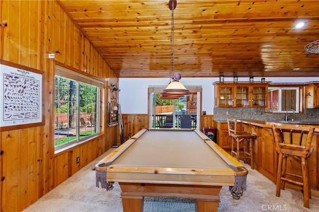 playroom featuring sink, wood ceiling, vaulted ceiling, wooden walls, and light colored carpet