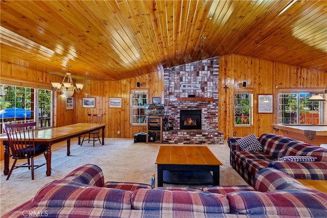 living room featuring wood walls, lofted ceiling, a healthy amount of sunlight, and carpet floors