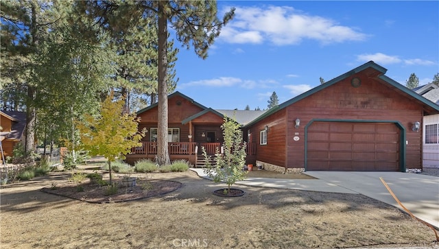 chalet / cabin with an attached garage and concrete driveway
