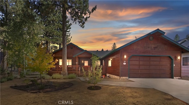 rustic home featuring an attached garage and driveway