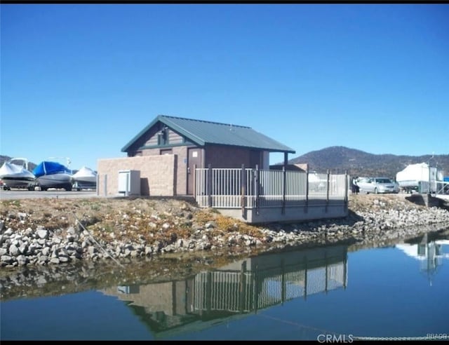 exterior space with a mountain view and fence