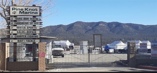 view of gate with a mountain view and fence