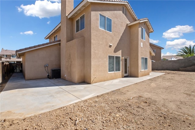 rear view of house featuring cooling unit and a patio area