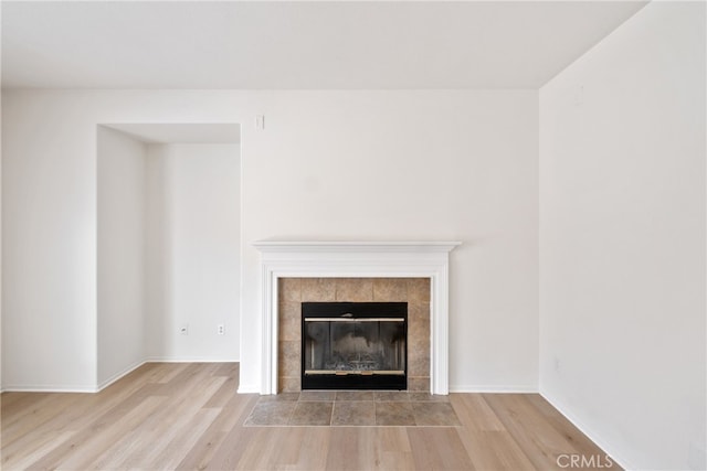 unfurnished living room featuring light hardwood / wood-style floors and a fireplace