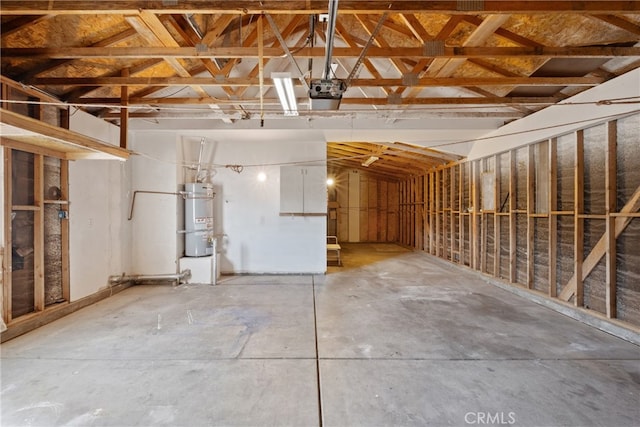 garage featuring a garage door opener and water heater