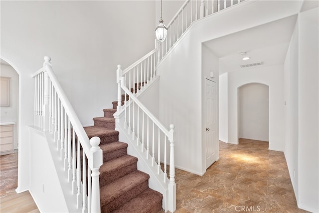 stairs featuring a high ceiling