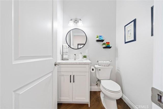 bathroom featuring hardwood / wood-style floors, vanity, and toilet