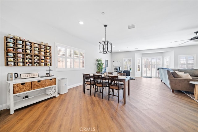 dining space with ceiling fan and light hardwood / wood-style flooring