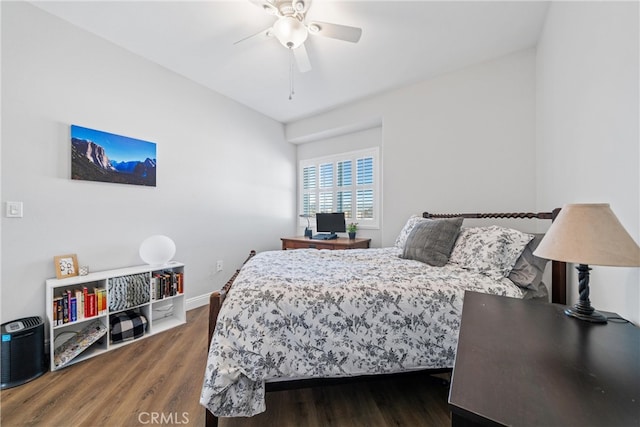 bedroom with ceiling fan and dark hardwood / wood-style floors