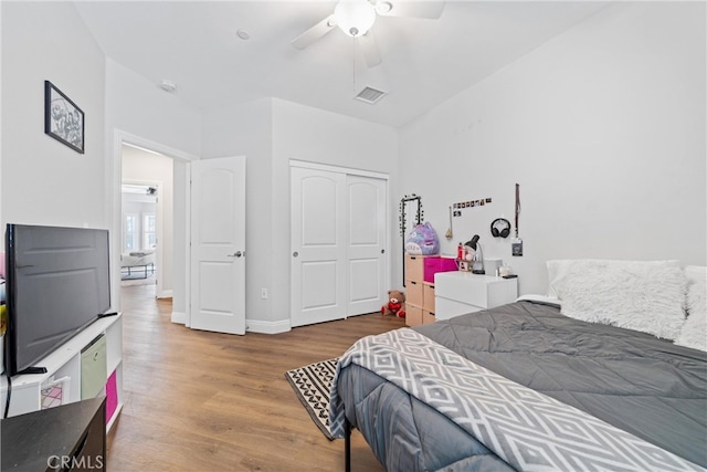 bedroom with a closet, ceiling fan, and hardwood / wood-style flooring