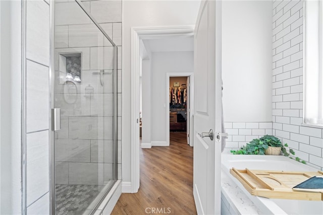 bathroom with separate shower and tub and hardwood / wood-style floors