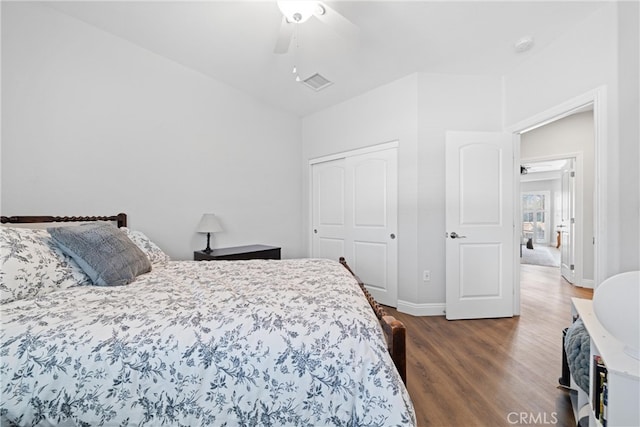 bedroom with ceiling fan and dark wood-type flooring