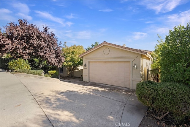 3185 Via Casita Pl, Chico, CA 95928 - view of side of home with stucco siding, concrete driveway, and an outdoor structure