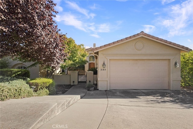 3185 Via Casita Pl, Chico, CA 95928 - view of front of house with a gate, stucco siding, concrete driveway, and an attached garage