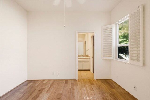 spare room with sink and light wood-type flooring