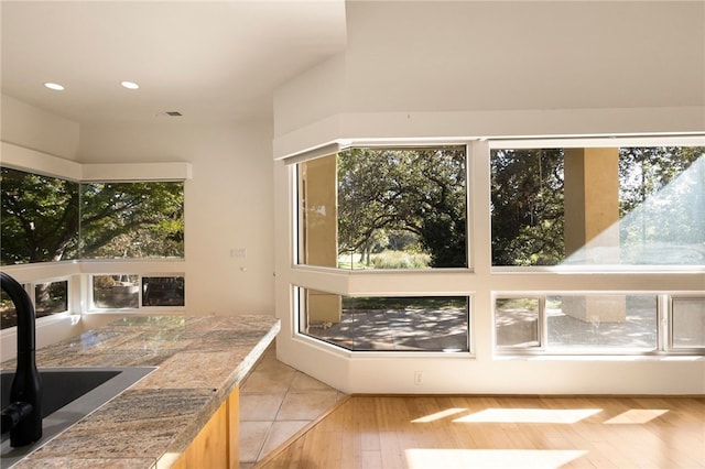 sunroom with plenty of natural light and sink