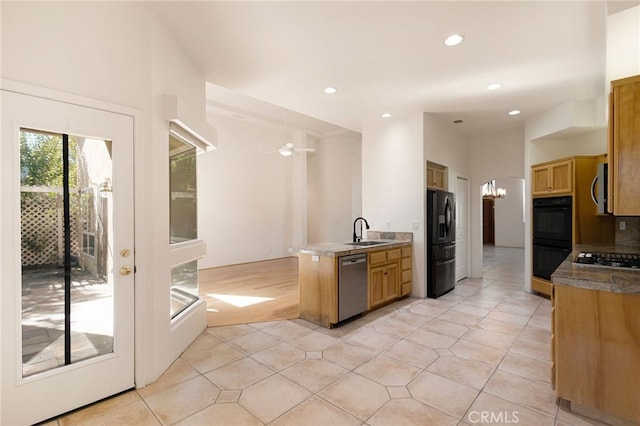 kitchen featuring ceiling fan with notable chandelier, light tile patterned floors, sink, and black appliances