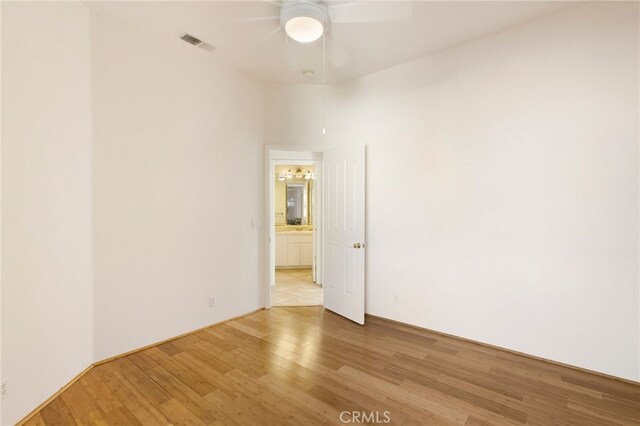 spare room featuring ceiling fan and light wood-type flooring