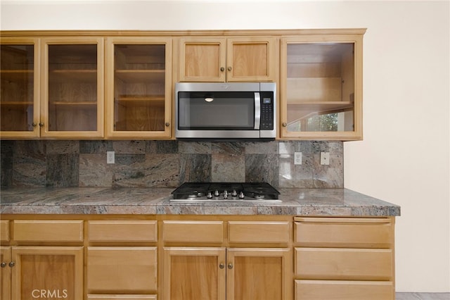 kitchen with decorative backsplash and stainless steel appliances