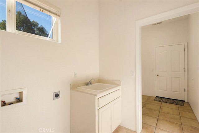 laundry room featuring sink, hookup for an electric dryer, hookup for a washing machine, and light tile patterned floors