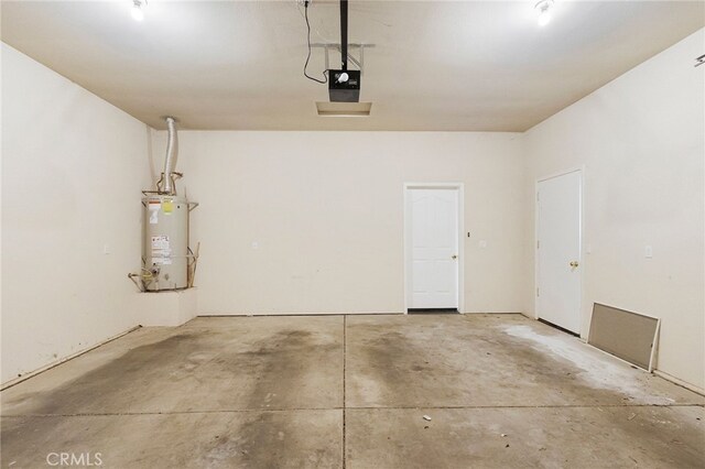 garage with a garage door opener and gas water heater