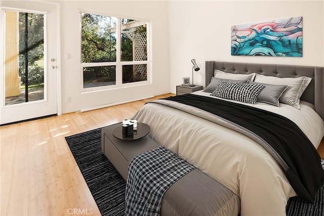 bedroom featuring wood-type flooring and multiple windows