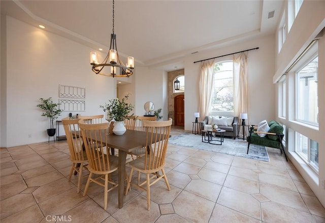 3185 Via Casita Pl, Chico, CA 95928 - dining space with a chandelier, light tile patterned flooring, recessed lighting, a towering ceiling, and a tray ceiling