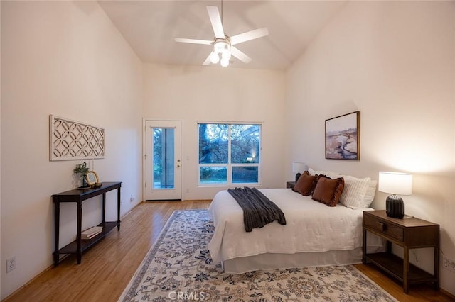 3185 Via Casita Pl, Chico, CA 95928 - bedroom featuring access to outside, wood finished floors, high vaulted ceiling, and a ceiling fan