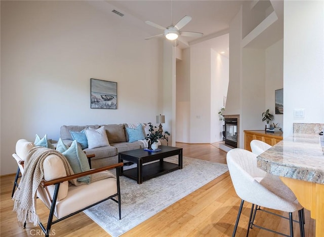 3185 Via Casita Pl, Chico, CA 95928 - living room featuring a ceiling fan, a fireplace, light wood finished floors, and high vaulted ceiling