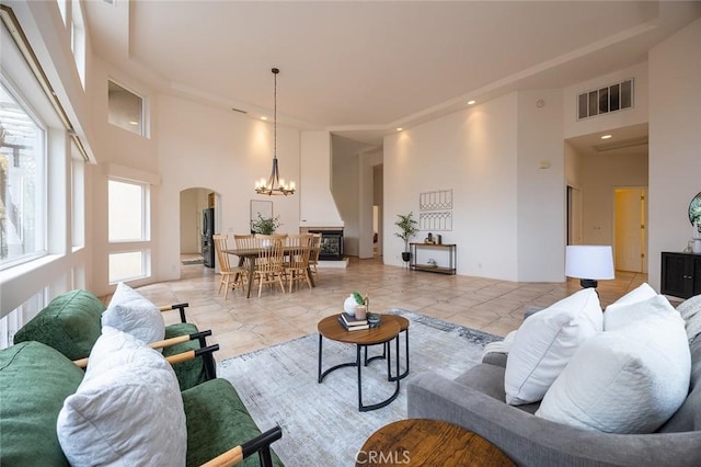 3185 Via Casita Pl, Chico, CA 95928 - living area featuring a towering ceiling, arched walkways, a chandelier, and recessed lighting