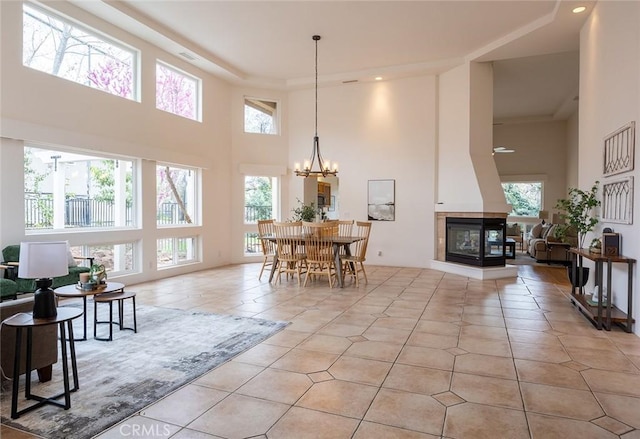3185 Via Casita Pl, Chico, CA 95928 - living area featuring a high ceiling, light tile patterned flooring, a multi sided fireplace, a chandelier, and recessed lighting