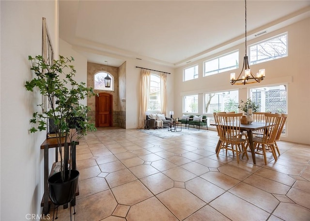 3185 Via Casita Pl, Chico, CA 95928 - dining area with a chandelier, light tile patterned flooring, and a high ceiling