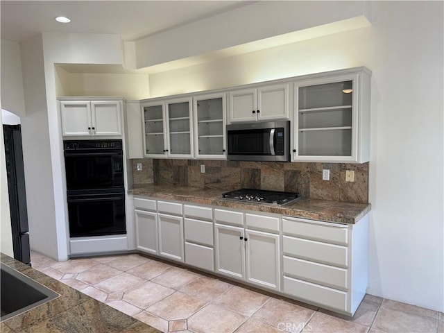 3185 Via Casita Pl, Chico, CA 95928 - kitchen featuring appliances with stainless steel finishes, tasteful backsplash, glass insert cabinets, and dark countertops