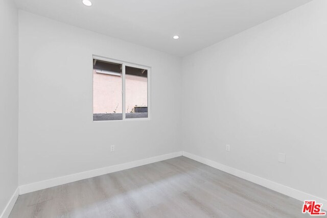 unfurnished room with light hardwood / wood-style flooring