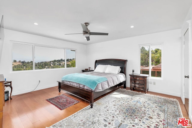 bedroom with ceiling fan and hardwood / wood-style flooring