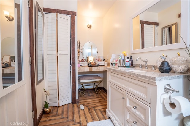 bathroom featuring parquet floors and vanity