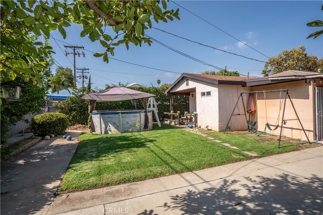 view of yard featuring a covered pool