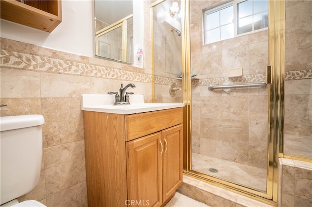 bathroom featuring tile walls, walk in shower, vanity, and toilet