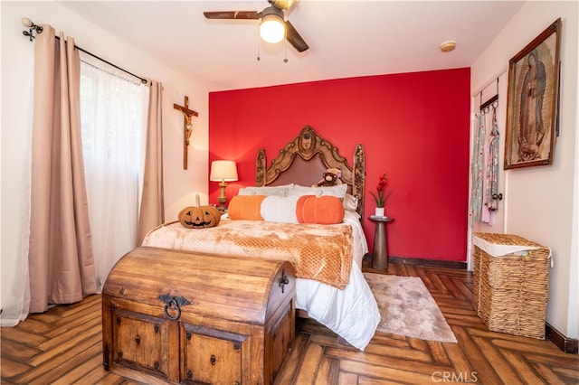 bedroom featuring ceiling fan and dark parquet flooring