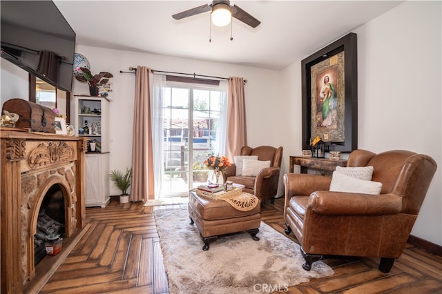 living area featuring ceiling fan and parquet floors