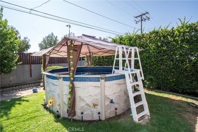 exterior space featuring a fenced in pool, a gazebo, and a yard