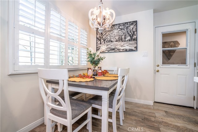 dining room with wood-type flooring and a chandelier