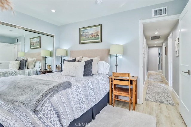 bedroom with a closet and light wood-type flooring