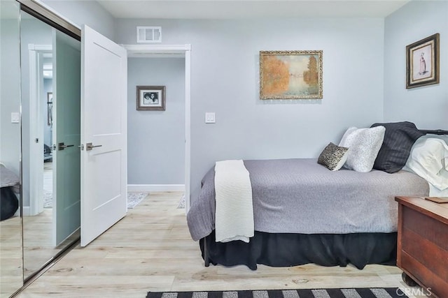 bedroom featuring a closet and light wood-type flooring