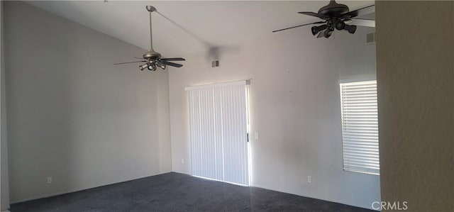 carpeted spare room featuring lofted ceiling and ceiling fan