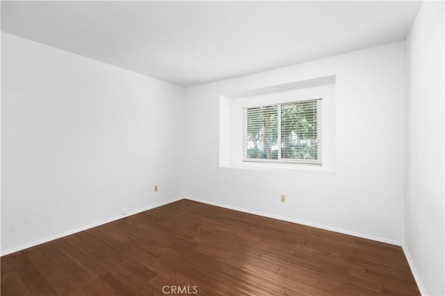 spare room featuring hardwood / wood-style flooring