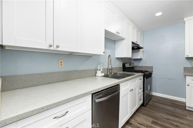 kitchen with dark hardwood / wood-style flooring, light stone counters, stainless steel appliances, sink, and white cabinetry