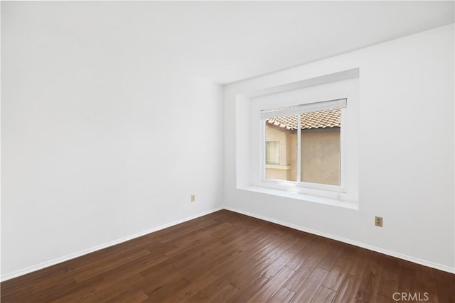 spare room with hardwood / wood-style flooring