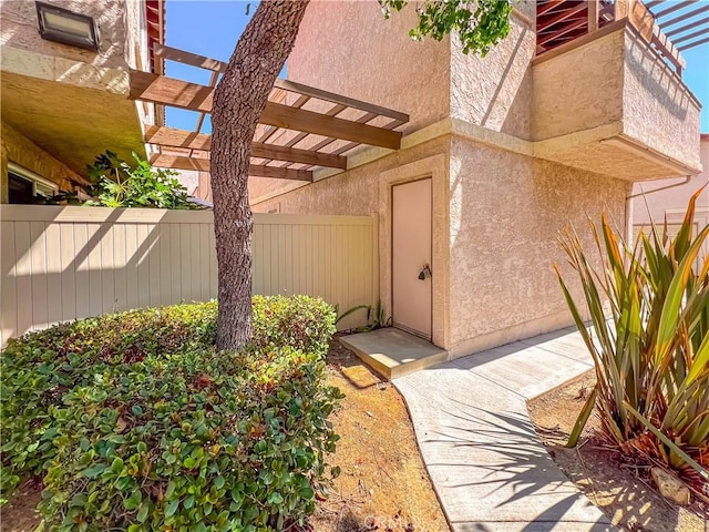 doorway to property featuring a pergola